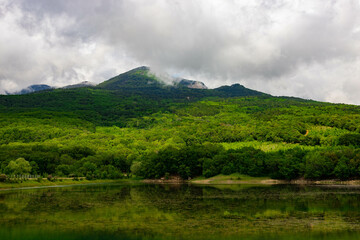 Mountain lake with mountain views and clouds.