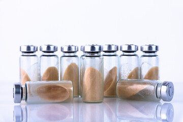 Vials, ampoules with dry probiotic, bifidobacteria, with probiotic powder inside on a white...
