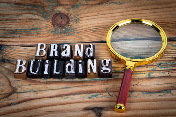 BRAND BUILDING. Alphabet letters on wood texture background