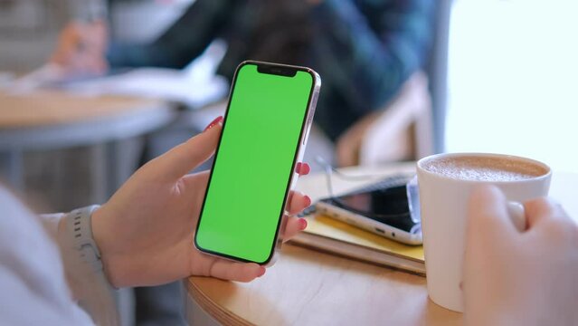 Businesswoman, hands or green screen phone in coffee shop, restaurant or cafe on social media app or calendar management. worker employee or mobile technology mockup of office logo on lunch break 4K