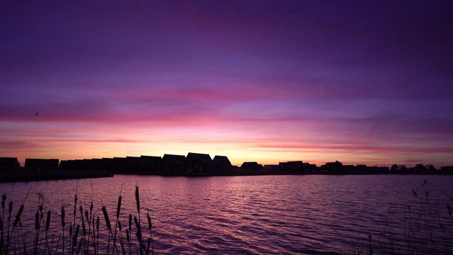 A colourful sunrise in a modern suburb at the waterfront in Meerstad, the Netherlands