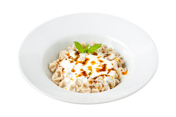 Kayseri ravioli or Kayseri Mantisi on a white plate on white background