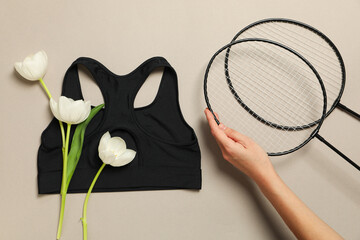 Sports accessories with spring flowers, on a light background.