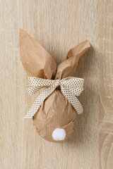 Chocolate egg in a wrapper on a wooden background