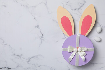 Blue gift box with rabbit ears on a light background