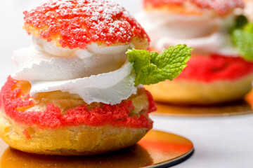 Shu cake. Custard dessert with creamy white cream, decorated with raspberries.