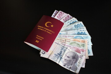 Turkish banknotes in Turkish passport.The paper currency of Turkey. Current Turkish liras are issued by The Central Bank of the Republic of Turkey. 