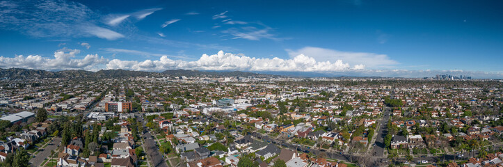 Aerial panorama of city of Los Angeles cityscape panorama with fluffy clouds, downtown LA skyline in background