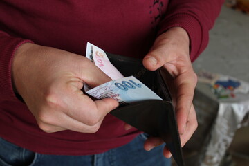 Man hand holding an open empty wallet close up. Poverty, cost control expenses, spent too much, not...
