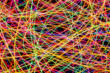 Chaos texture. Neon lights background. Motion lines texture. Long exposure moving light pattern. Abstract night life background. Glowing lines design. Colorful illumination.