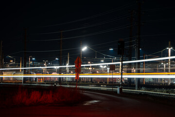 Nighttime View of Train Passing Through Electric Railway Station