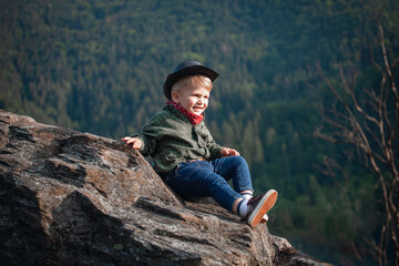 Cute Little Smiling Happy Boy with Hat and Bandana in Rocky Mountains - 742496732