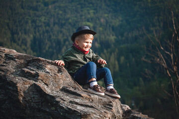 Cute Little Smiling Happy Boy with Hat and Bandana in Rocky Mountains - 742496796