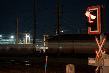 Railway Crossing with Blurred Train in Motion at Night