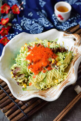 Delicious crab, tuna, fruit and vegetable salad on a plate