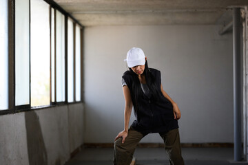 Young beautiful hip hop dancer dancing in an abandoned building. Movement and active lifestyle...