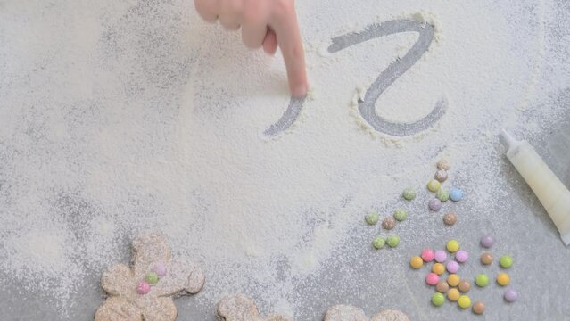 a Child's Hand Draws 2024 in Flour