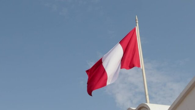 Peru flag waving in the wind with view to the sky