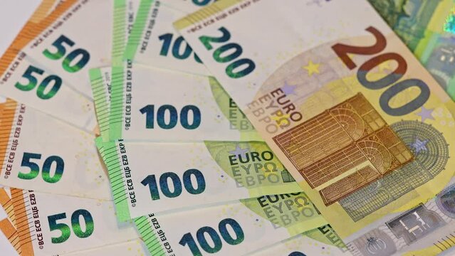 Different euro banknotes in slow rotation as background