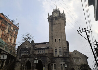 The heritage 100-foot-high stone Clock Tower still works in Darjeeling, India. The structure was constructed by Raj Sahib Kharga Bahadur Chettri in 1850  Dr. Cambell from England put a clock in 1920. - obrazy, fototapety, plakaty