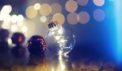 Christmas Gift Present In Ball Hanging Fir Branch With Bokeh Lights On Blue Abstract Eve Night