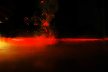 Red smoke over black studio background. Red steam on a black background. Copy space.