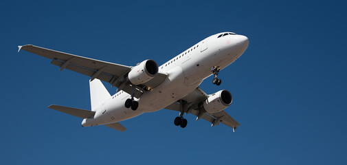 The plane lands.Airplane, passengers flying in the blue sky, preparing to land at the airport	