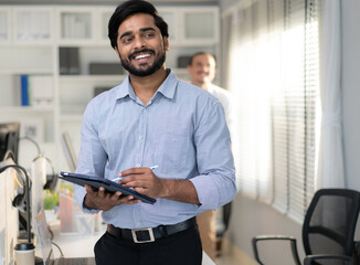 Indian businessman happy working in corporate office. Confident smart bearded man entrepreneur hold...