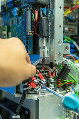 Man's hand repairing an electronic board