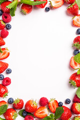 Frame berry background made from strawberry, raspberry and blueberry over white, top view, flat lay. Creative food concept with copy space