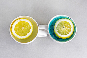two cups with lemon slices on the table. Psychology health and attitude