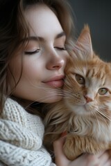 A young woman cuddles her cute kitten, symbolizing friendship and care in a domestic setting.