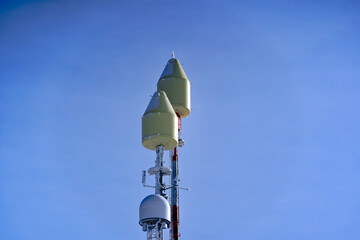 Close-up of concrete and metal communications tower on top of Titlis mountain on a sunny winter...