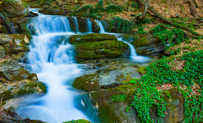 small waterfal on summer mountain river