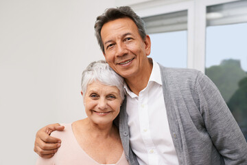 Hug, senior or portrait of happy couple in home for bonding together with support, love or smile. Retirement, people or romantic mature man with an elderly woman for trust, peace or care in marriage