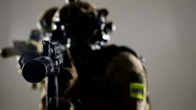 SWAT team with guns aiming in target, portrait of two men in modern military equipment