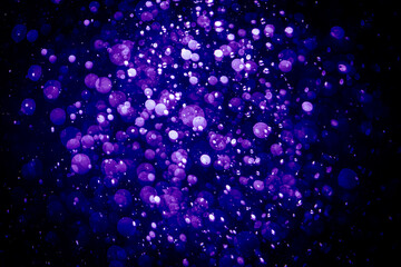 Blurred photo with purple violet and blue dots visible glittering, shining brightly look and feel luxurious