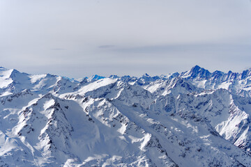 Fototapeta na wymiar Scenic view of mountain panorama with snow covered mountain peaks in the Swiss Alps at mount Titlis on a sunny winter day. Photo taken February 21st, 2024, Titlis, Engelberg, Switzerland.