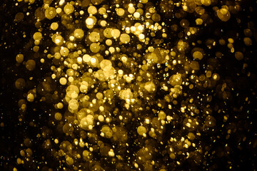 Blurred photo with golden dots visible glittering, shining brightly look and feel luxurious