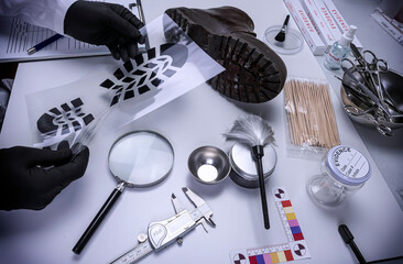 Forensic scientist investigates shoeprint mould evidence in crime lab, conceptual image - obrazy, fototapety, plakaty