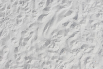 Fine white sand that glistens and reflects the sunlight.