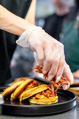 woman chef hand cooking pancakes with meat, bacon and cheese sauce
