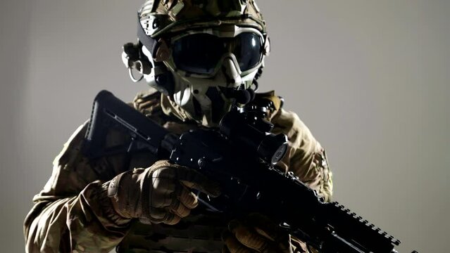 portrait of soldier in modern uniform with protective helmet and bulletproof jacket, holding rifle