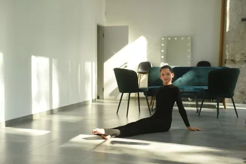 Fototapeten person doing yoga. ballet dancers in ballroom. woman doing yoga exercise © Hanna
