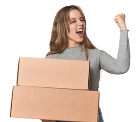 Blonde woman with cardboard boxes moving on studio backdrop raising fist after a victory, winner concept.