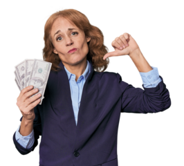 Mid-aged Caucasian with dollars in studio showing a dislike gesture, thumbs down. Disagreement concept.