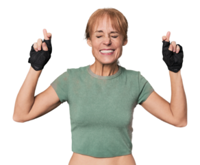 Mid-aged Caucasian athlete with gloves crossing fingers for having luck