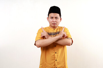 Young asian muslim man Pointing to both sides with fingers, different direction disagree and confuse