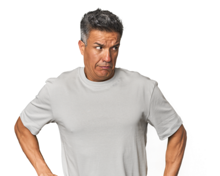 Middle-aged Latino man confused, feels doubtful and unsure.
