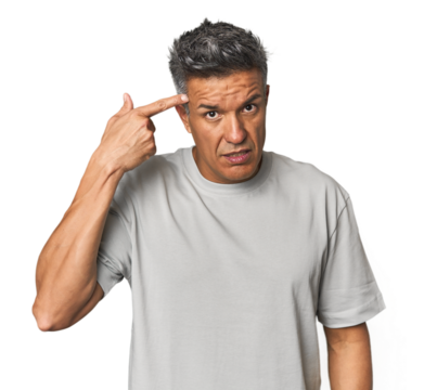 Middle-aged Latino man showing a disappointment gesture with forefinger.